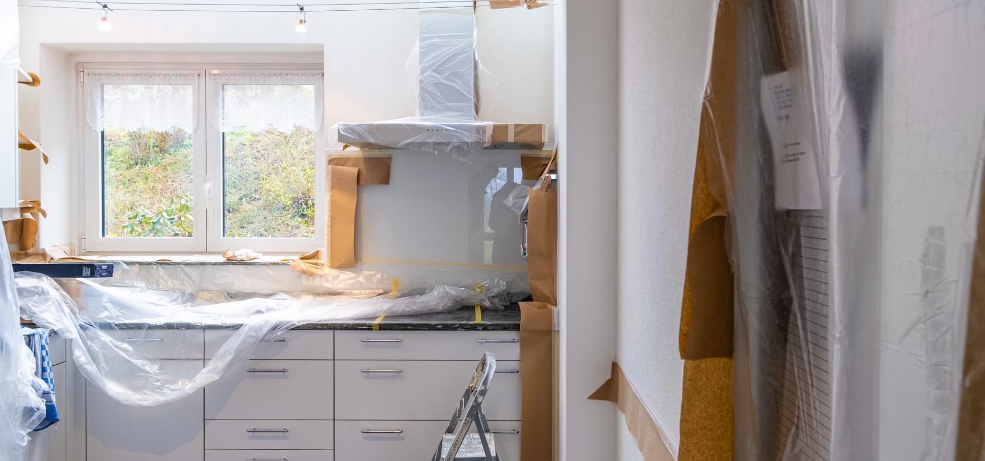 A room part-way through a renovation, dust sheets down