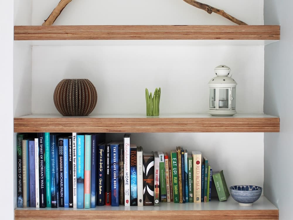 Built-in timber shelves holding books and ornaments