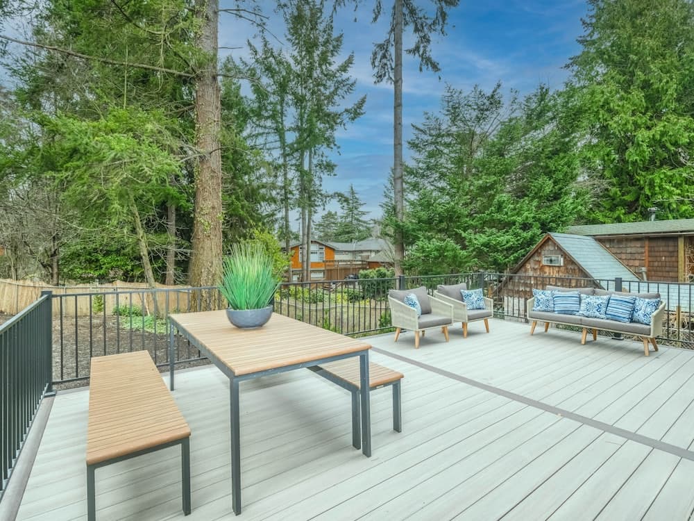 A finished timber deck with outdoor table and chairs