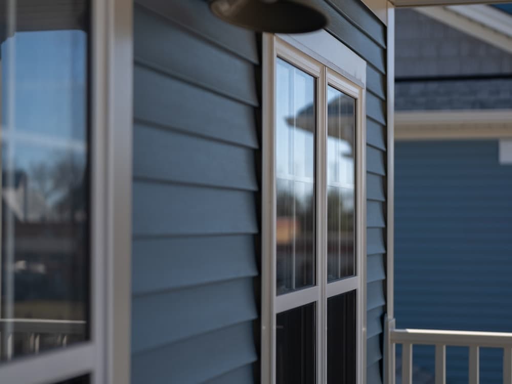 A house with freshly painted blue siding and white trim