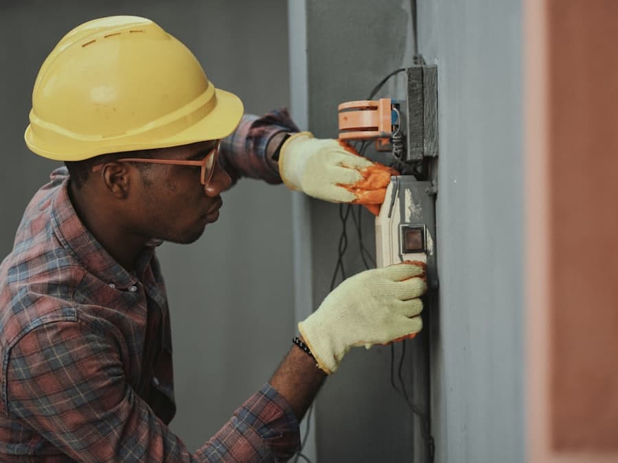 An electrician wiring a wall outlet