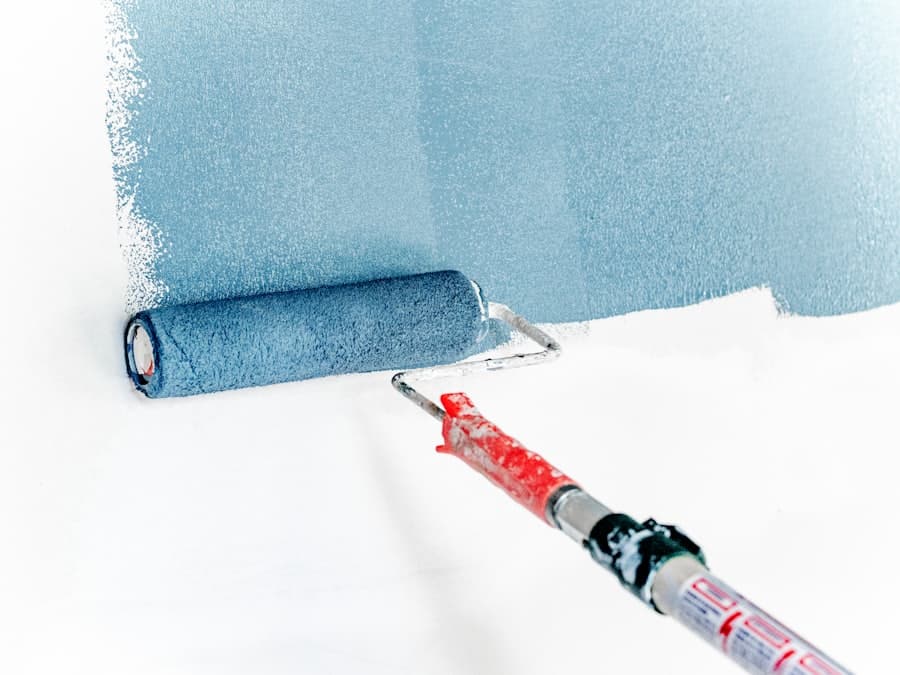 A roller laying a coat of paint onto a wall